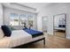 Bright main bedroom featuring wood floors, large windows, and a view to the shower at 1118 Eagles Pass Way, Winter Garden, FL 34787