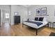 Well-lit main bedroom with hardwood floors, modern furniture, tray ceiling, and a neutral color palette at 1118 Eagles Pass Way, Winter Garden, FL 34787