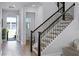 Welcoming foyer with wooden staircase, neutral decor, and an open entryway for guests at 1118 Eagles Pass Way, Winter Garden, FL 34787