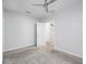 Neutral bedroom featuring grey carpet, a modern ceiling fan, and an open doorway at 115 E Concord St # 3, Orlando, FL 32801