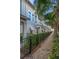 Street view of townhomes with lush landscaping and a black iron fence at 115 E Concord St # 3, Orlando, FL 32801