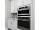 Modern kitchen featuring stainless steel built in appliances and white cabinetry at 115 E Concord St # 3, Orlando, FL 32801