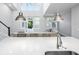 Bright, open kitchen with a white countertop, stainless steel sink, and pendant lighting overlooking the living area at 115 E Concord St # 3, Orlando, FL 32801