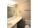 Simple bathroom featuring a white toilet, a large mirror and a vanity sink at 120 Blue Point Way # 360, Altamonte Springs, FL 32701