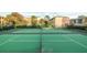 Full view of well-maintained tennis courts with green surfaces and surrounding buildings at 120 Blue Point Way # 360, Altamonte Springs, FL 32701