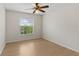 Cozy bedroom featuring hardwood floors, ceiling fan, and natural light from the bright window at 13325 Falcon Pointe Dr, Orlando, FL 32837