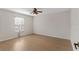 Bright bedroom with hardwood floors, ceiling fan, and natural light from the bright window at 13325 Falcon Pointe Dr, Orlando, FL 32837