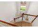 Bright foyer with a two story ceiling, decorative chandelier, tile floors, and staircase with wood banister at 13325 Falcon Pointe Dr, Orlando, FL 32837