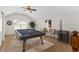 This game room includes a dart board, pool table, and cozy seating area at 13325 Falcon Pointe Dr, Orlando, FL 32837