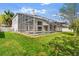 Wide view of the screened in pool with outdoor living space on a manicured lawn at 13325 Falcon Pointe Dr, Orlando, FL 32837