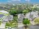 An aerial view of the neighborhood and home showing a screened pool and nearby pond at 13812 Magnolia Glen Cir, Orlando, FL 32828