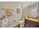 Half bath with granite countertop, dark cabinetry and decorative wall art at 13812 Magnolia Glen Cir, Orlando, FL 32828