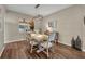 Charming dining room with stylish table set, elegant light fixture, and hardwood floors at 13812 Magnolia Glen Cir, Orlando, FL 32828