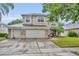 Two story home with three car garage and basketball hoop at 13812 Magnolia Glen Cir, Orlando, FL 32828