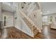 Bright foyer with staircase and wood flooring, leading to the main living areas at 13812 Magnolia Glen Cir, Orlando, FL 32828