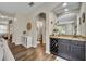 Hallway leading to a bar area and bathroom with wood floors and neutral paint at 13812 Magnolia Glen Cir, Orlando, FL 32828