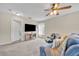 Cozy living room featuring a ceiling fan, large television and comfortable seating at 13812 Magnolia Glen Cir, Orlando, FL 32828