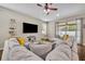 Comfortable living room with large sectional, ceiling fan and sliding glass doors to outdoor space at 13812 Magnolia Glen Cir, Orlando, FL 32828