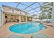 Enclosed pool and patio with a spa and plenty of seating at 13812 Magnolia Glen Cir, Orlando, FL 32828