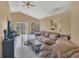 Bright living room with vaulted ceiling, tile floors and access to the backyard at 1525 Rivers Edge Dr, Orlando, FL 32825