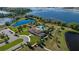 Stunning aerial view of a community clubhouse, showcasing a sparkling pool, lush landscaping, and surrounding lakes at 15926 Marina Bay Dr, Winter Garden, FL 34787