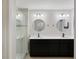 Beautiful bathroom featuring dual sinks, black cabinets, and a glass shower at 15926 Marina Bay Dr, Winter Garden, FL 34787