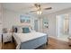 Comfortable bedroom with a ceiling fan, light-colored walls, and decorative touches at 15926 Marina Bay Dr, Winter Garden, FL 34787