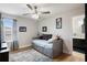 Cozy bedroom featuring a ceiling fan, a daybed with storage, and access to an en-suite bathroom at 15926 Marina Bay Dr, Winter Garden, FL 34787