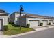 Exterior view of a townhome featuring an attached garage, manicured lawn, and modern lamppost at 15926 Marina Bay Dr, Winter Garden, FL 34787