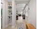 Open hallway leads to living spaces, featuring tiled floors and built-in shelving at 15926 Marina Bay Dr, Winter Garden, FL 34787