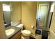 Half bathroom featuring a marble countertop vanity, standard toilet, and access to outdoors at 1924 Eloise Cove Dr, Winter Haven, FL 33884