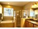 Bright bathroom featuring a glass-enclosed shower, separate soaking tub, and a window at 1924 Eloise Cove Dr, Winter Haven, FL 33884