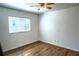 White bedroom features laminate floors, natural light from the window, and ceiling fan at 1924 Eloise Cove Dr, Winter Haven, FL 33884