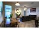 Bright living room with tile floors, ceiling fan, and large windows, creating a comfortable and inviting space at 1924 Eloise Cove Dr, Winter Haven, FL 33884