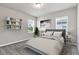 Cozy bedroom with natural light, neutral decor, and a stylish bookshelf, creating a cozy and inviting space at 2313 Mystic Maze Ln, Clermont, FL 34715