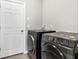 Laundry room with modern front load washer and dryer at 2313 Mystic Maze Ln, Clermont, FL 34715