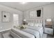 Serene main bedroom with neutral decor, plush bedding, and stylish bedside tables for a relaxing retreat at 2313 Mystic Maze Ln, Clermont, FL 34715