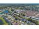 A high-angle drone shot showcasing the community pond, local school, and construction site at 2421 Hybrid Dr, Kissimmee, FL 34758