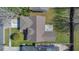 Aerial view of the home featuring a well-maintained roof, a driveway, and a lush green lawn at 2421 Hybrid Dr, Kissimmee, FL 34758