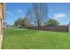 Large grassy backyard enclosed with a brick fence on sunny day at 2421 Hybrid Dr, Kissimmee, FL 34758