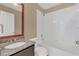 Well-lit bathroom featuring a shower-tub combination and granite countertop vanity at 2421 Hybrid Dr, Kissimmee, FL 34758