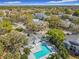 Wide aerial shot of community amenities, pools, and landscaping providing a sense of lifestyle and location at 2580 Grassy Point Dr # 100, Lake Mary, FL 32746