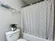 Cozy bathroom features patterned shower curtain, toilet, and a small potted plant at 2580 Grassy Point Dr # 100, Lake Mary, FL 32746