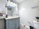 Well-lit bathroom with a vanity, decorative mirror, and updated fixtures at 2580 Grassy Point Dr # 100, Lake Mary, FL 32746