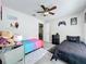 Charming bedroom featuring two beds, gaming decor, and a ceiling fan at 2580 Grassy Point Dr # 100, Lake Mary, FL 32746