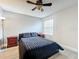 Cozy bedroom featuring a dark bed, neutral walls, and matching nightstands at 2580 Grassy Point Dr # 100, Lake Mary, FL 32746