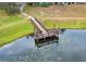 Aerial view of the community's pier extending over a small lake at 2580 Grassy Point Dr # 100, Lake Mary, FL 32746