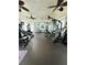 Community gym equipped with weight machines, ceiling fans, and a door to the outside at 2580 Grassy Point Dr # 100, Lake Mary, FL 32746