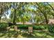 Serene backyard setting with mature trees, offering a peaceful atmosphere at 2930 Westgate Dr, Eustis, FL 32726