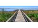 Long wooden dock extending over water surrounded by aquatic vegetation, perfect for waterfront activities at 2930 Westgate Dr, Eustis, FL 32726
